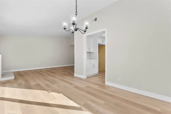 a view of a chandelier fan and entryway