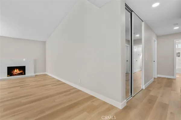 a view of an empty room with a fireplace