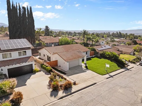 an aerial view of multiple houses with a yard