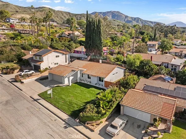 an aerial view of residential houses with outdoor space