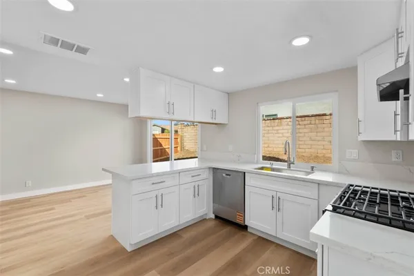 a kitchen that has a sink and a stove in it