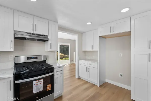 a kitchen with stainless steel appliances granite countertop a stove and a refrigerator