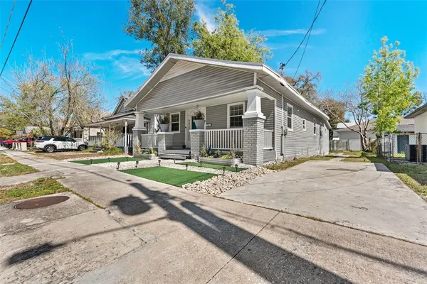 a front view of a house with a yard and trees