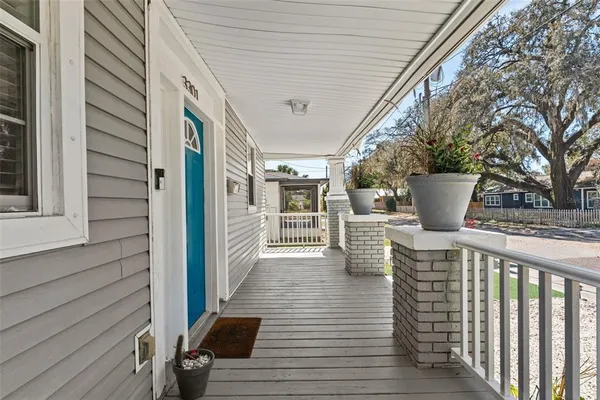 a view of a patio with wooden floor and fence