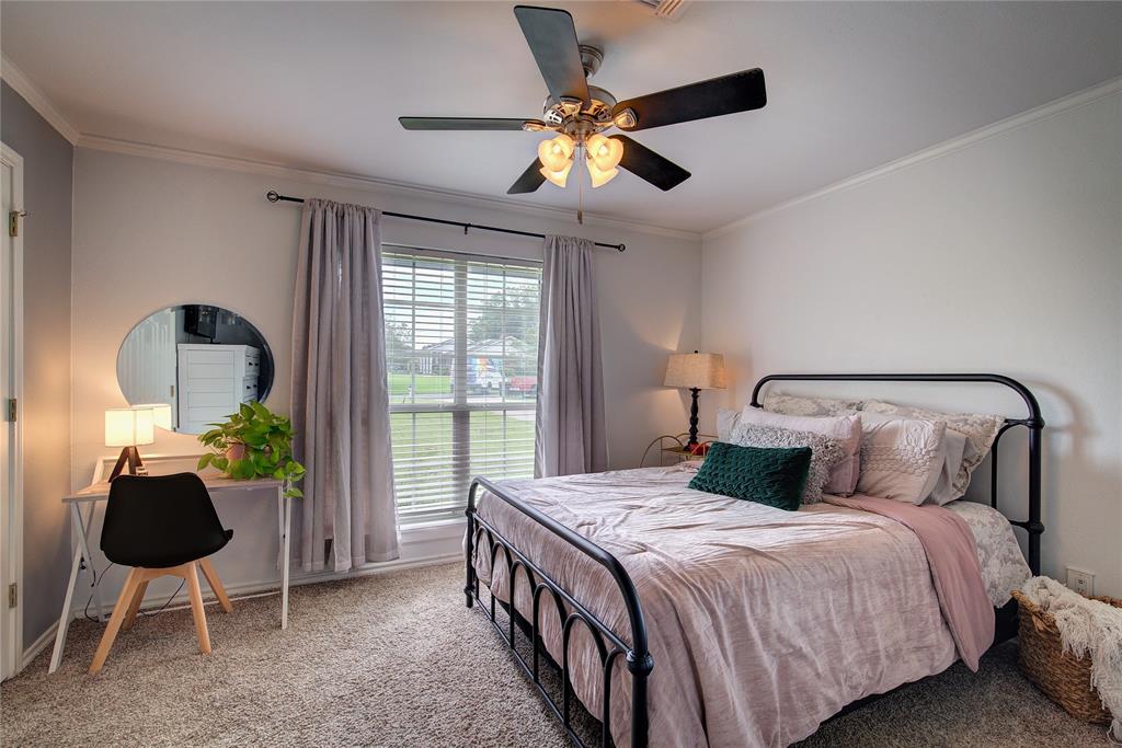 2027 Park Springs Road Sulphur Springs, TX 75482 - Photo 25 of 39 a bedroom with a bed and a chandelier