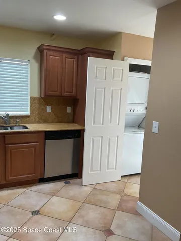 a bathroom with a granite countertop sink a toilet and a mirror