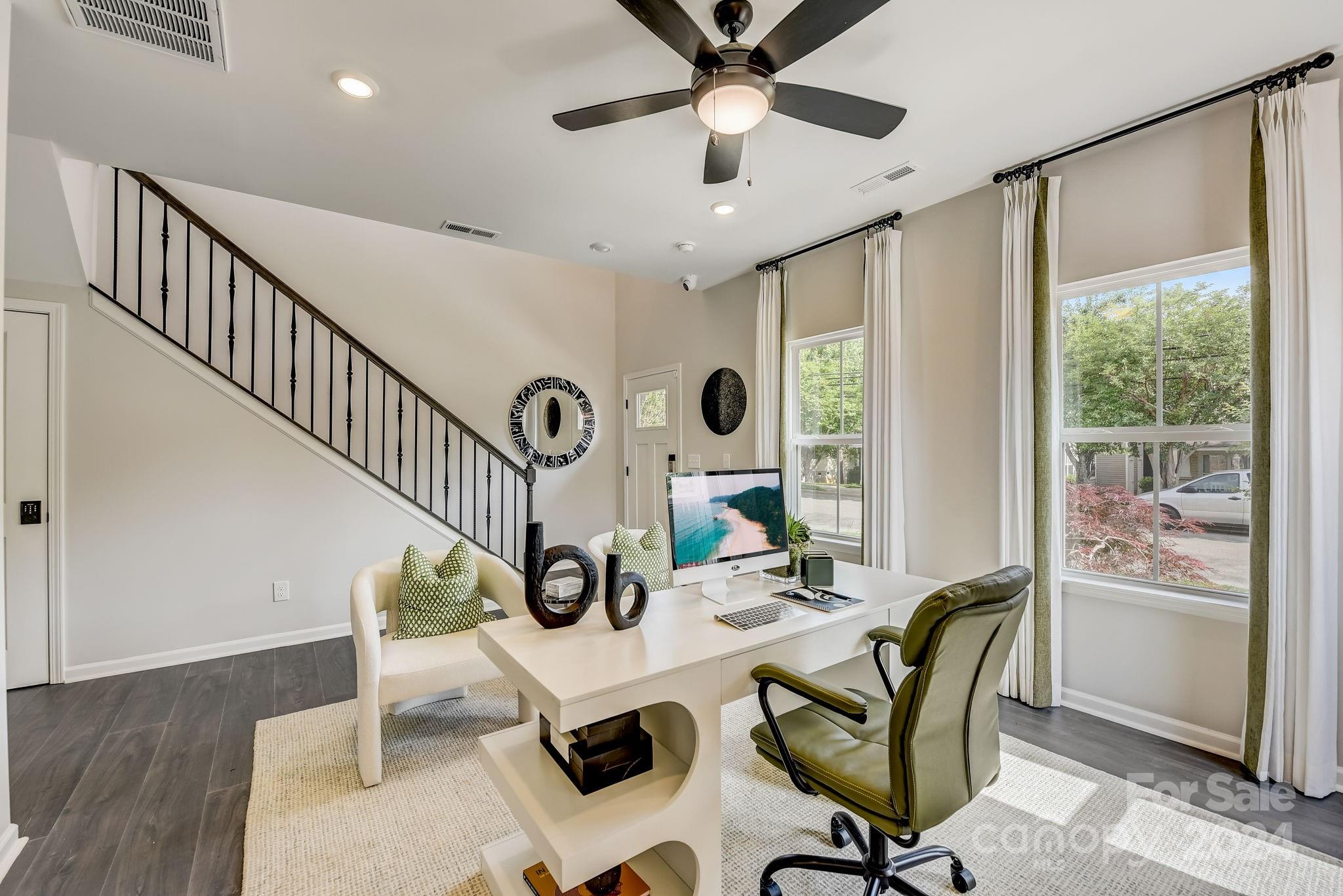 109 Goodson Place Davidson, NC 28036 - Photo 12 of 40 a living room with couches a dining table and a large window with wooden floor