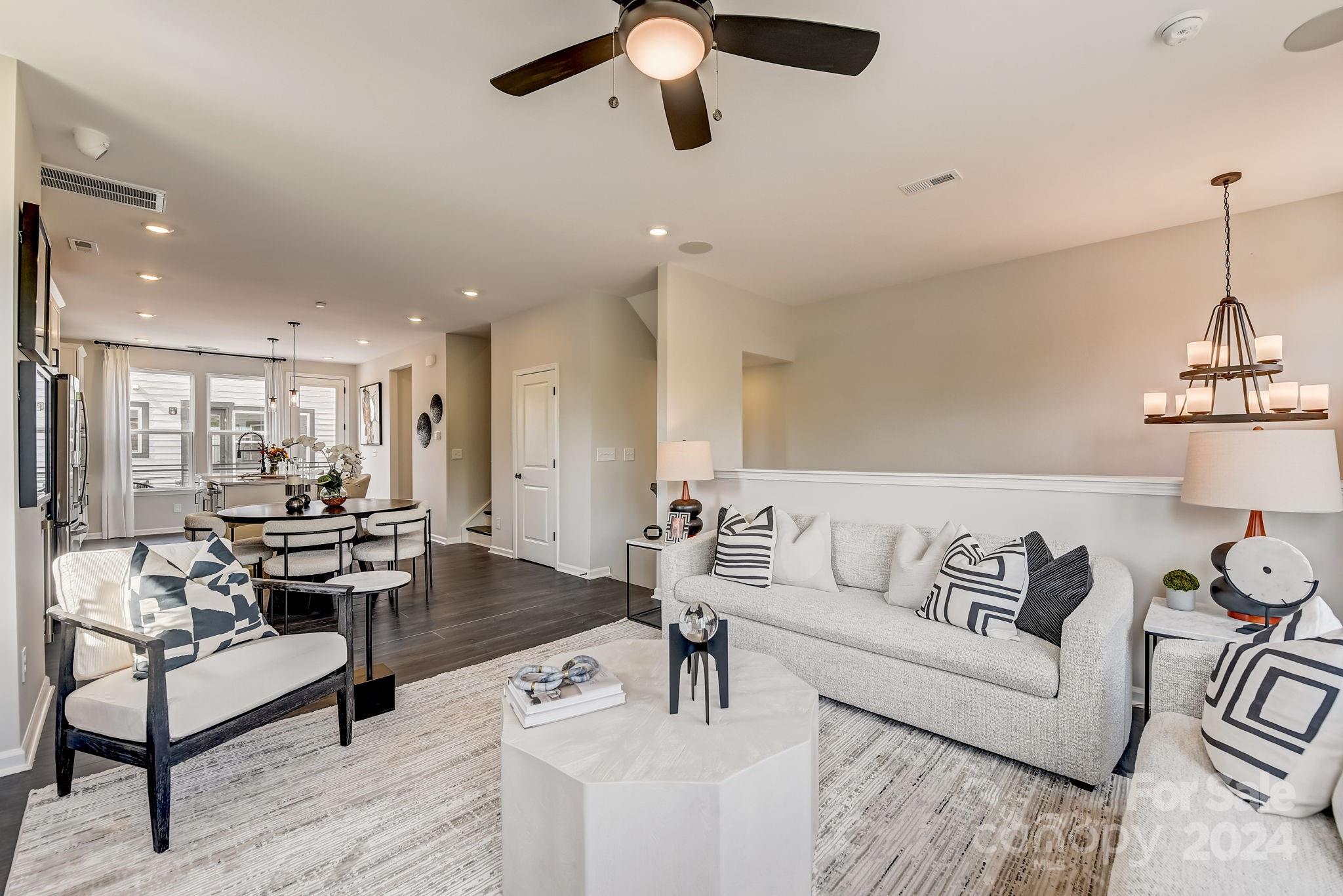 109 Goodson Place Davidson, NC 28036 - Photo 16 of 40 a living room with furniture and a chandelier