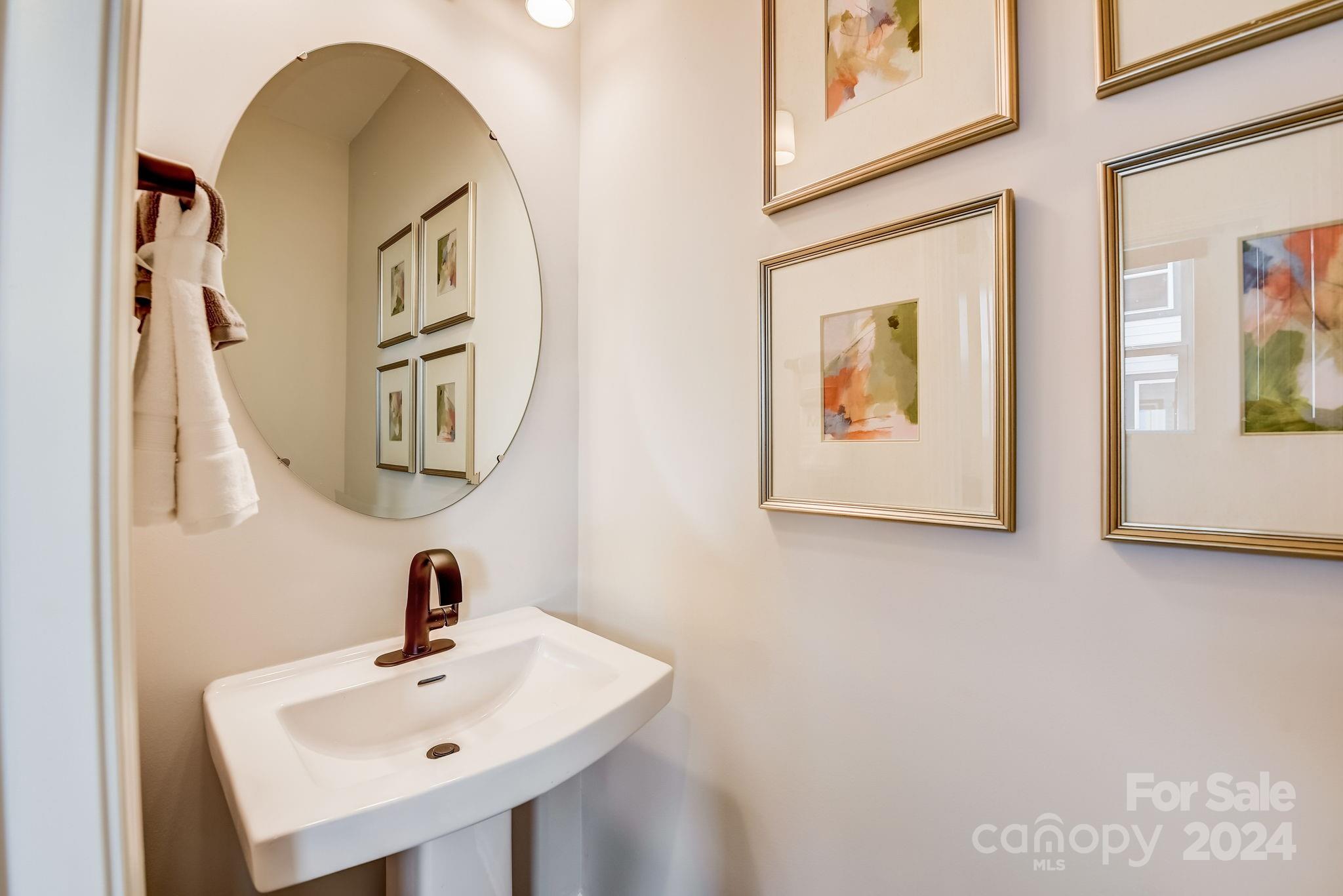 109 Goodson Place Davidson, NC 28036 - Photo 24 of 40 a bathroom with a sink and mirror