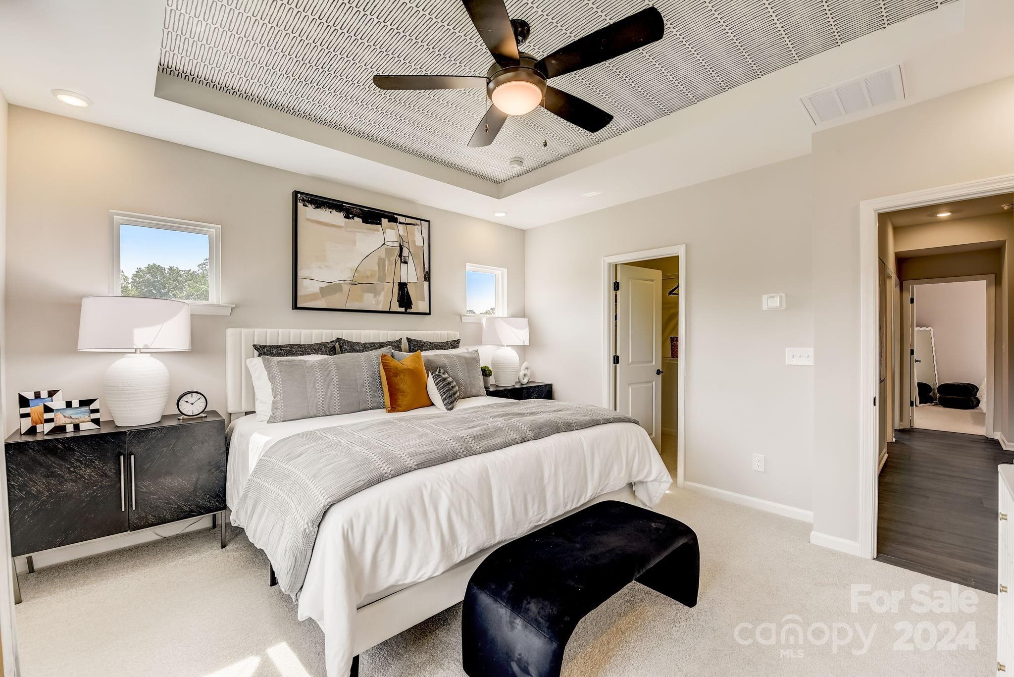 109 Goodson Place Davidson, NC 28036 - Photo 26 of 40 a bedroom with double bed and a chandelier