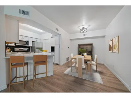 a living room with stainless steel appliances kitchen island granite countertop furniture and a view of kitchen