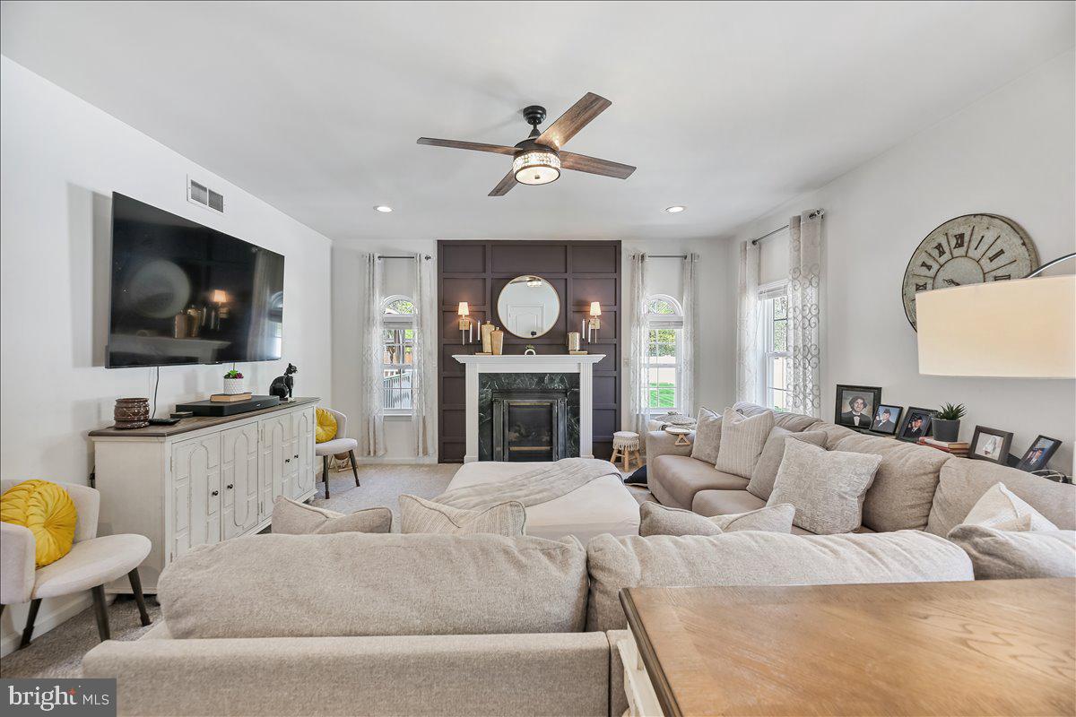 201 Prancer Road Egg Harbor Township, NJ 08234 - Photo 11 of 66 a living room with furniture a fireplace and a flat screen tv