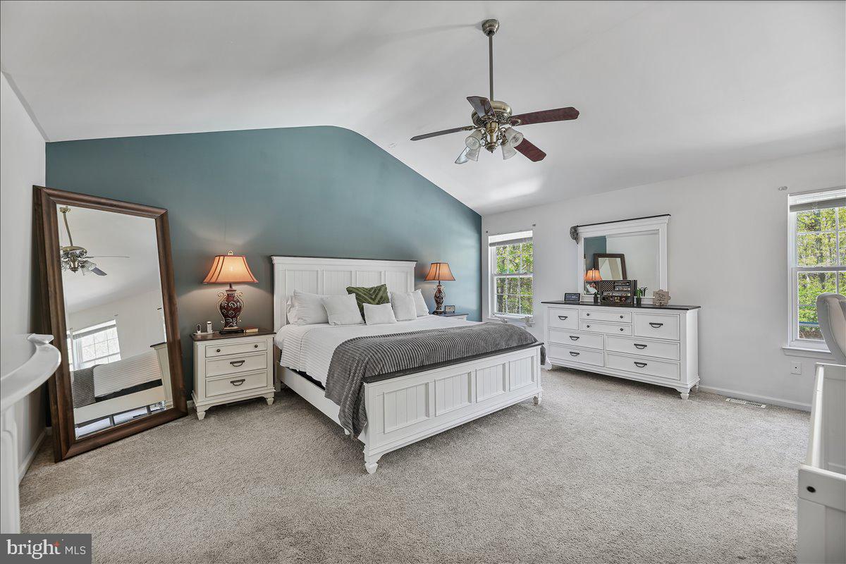 201 Prancer Road Egg Harbor Township, NJ 08234 - Photo 26 of 66 a bedroom with a large bed and a chandelier