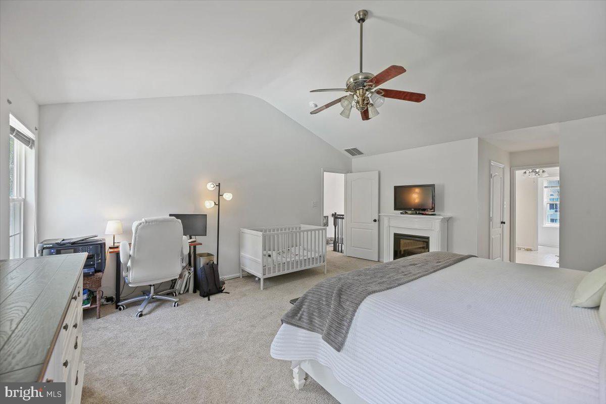 201 Prancer Road Egg Harbor Township, NJ 08234 - Photo 28 of 66 a spacious bedroom with a bed a chair and potted plant on the dresser