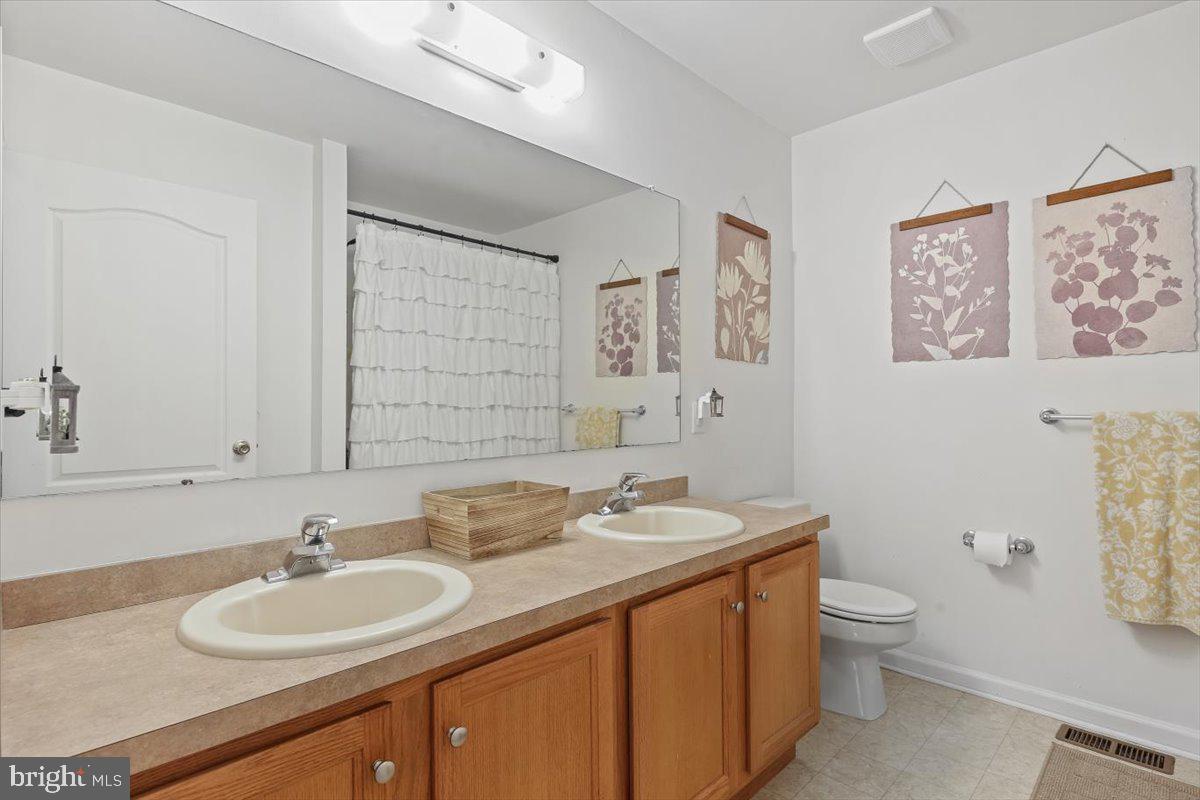 201 Prancer Road Egg Harbor Township, NJ 08234 - Photo 33 of 66 a bathroom with a granite countertop sink a toilet and a mirror