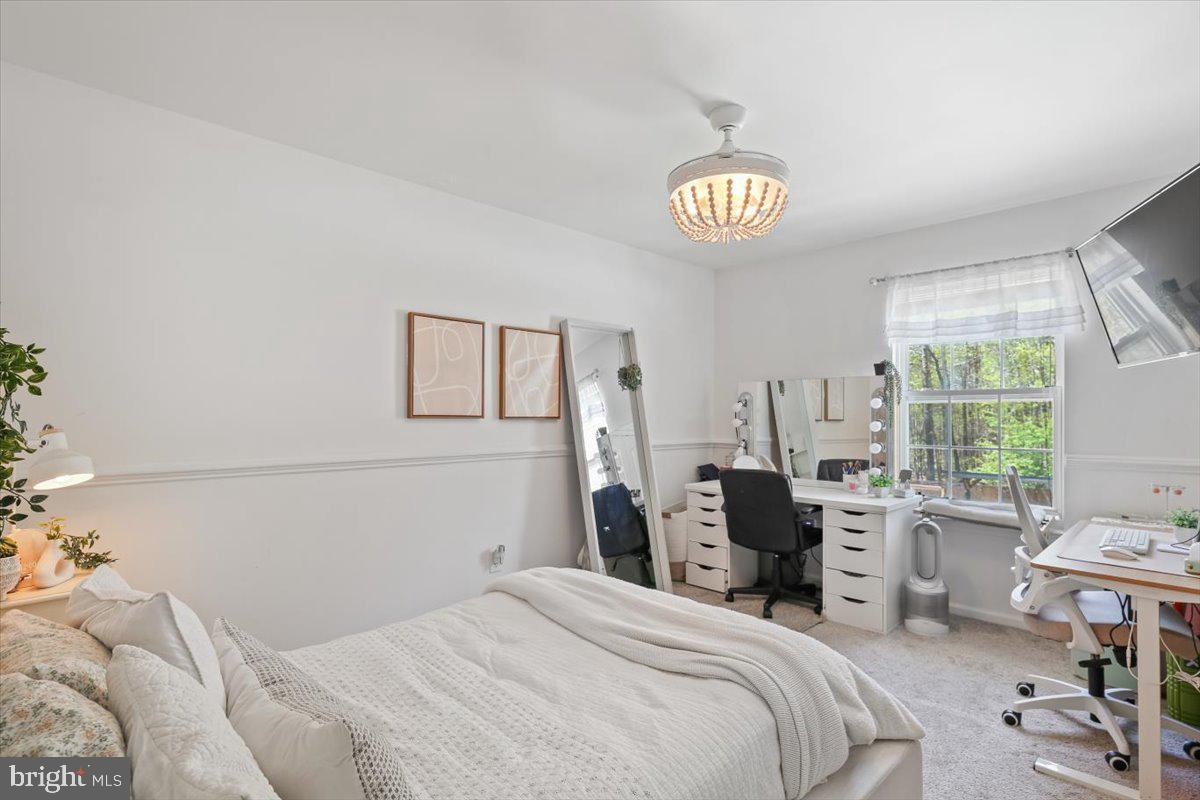 201 Prancer Road Egg Harbor Township, NJ 08234 - Photo 35 of 66 a bedroom with a bed and a table in it with window