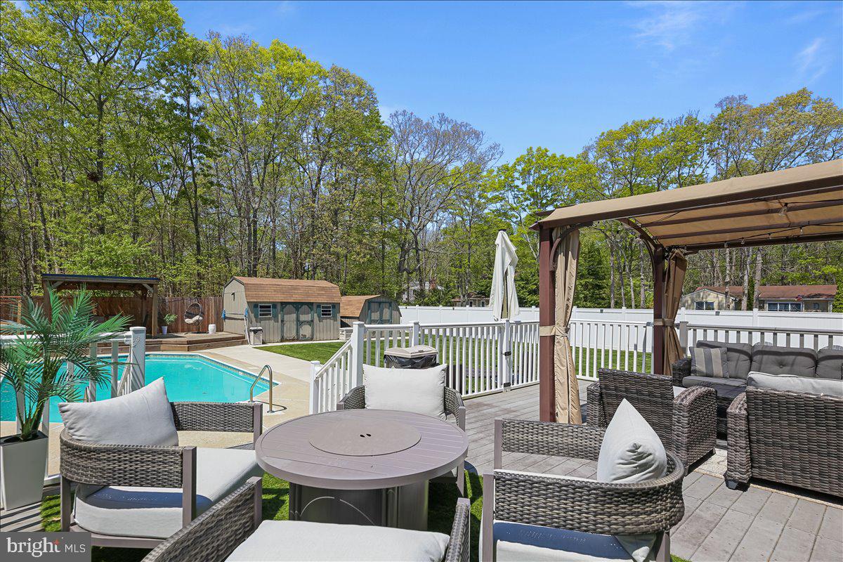 201 Prancer Road Egg Harbor Township, NJ 08234 - Photo 47 of 66 a view of a patio with a dining table and chairs