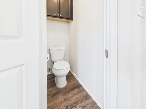 a white toilet sitting next to a small yard