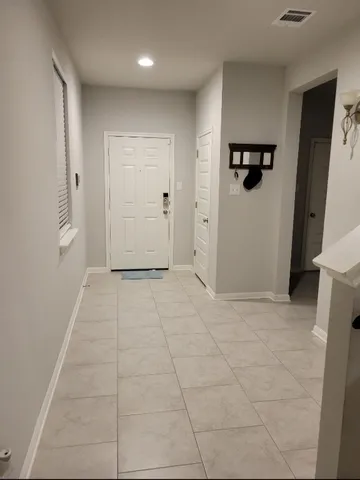 a white kitchen with a sink and microwave