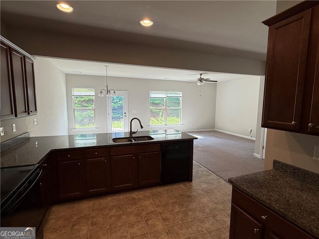 149 Hardy Water Drive Southeast Lawrenceville, GA 30045 - Photo 5 of 8 a large kitchen with granite countertop a sink and cabinets