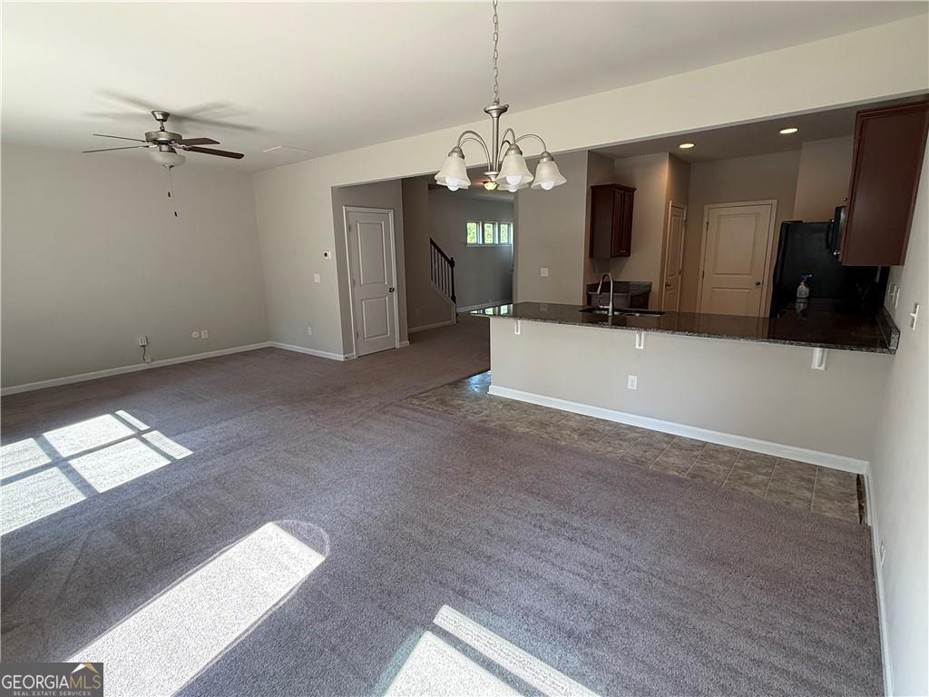 149 Hardy Water Drive Southeast Lawrenceville, GA 30045 - Photo 6 of 8 a view of a livingroom with a chandelier