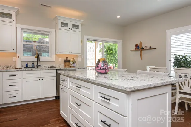 a kitchen with sink cabinets and wooden floor