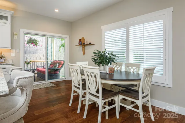 a view of a dining room with furniture and windows