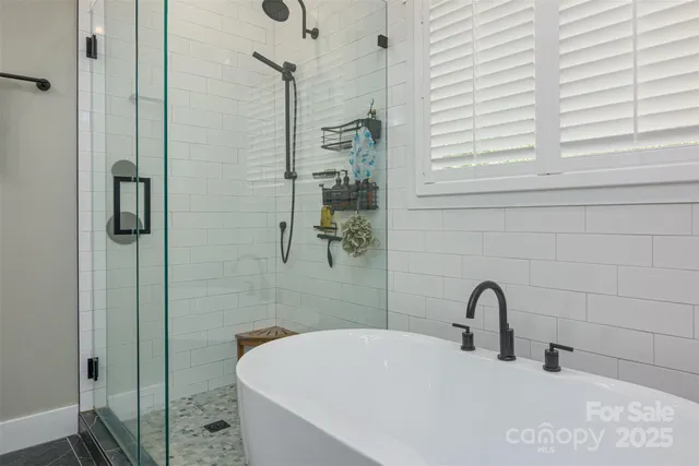 a bathroom with a sink a shower and a mirror