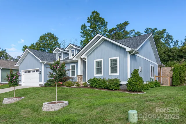 a front view of house with a garden