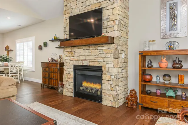 a living room with fireplace furniture and a flat screen tv