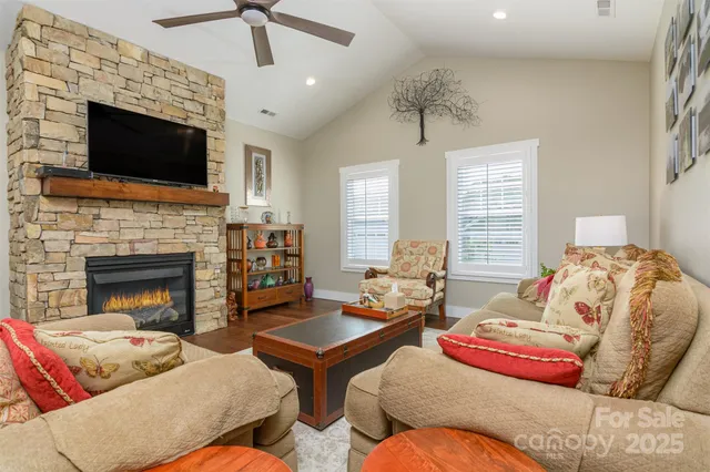 a living room with furniture fireplace and flat screen tv