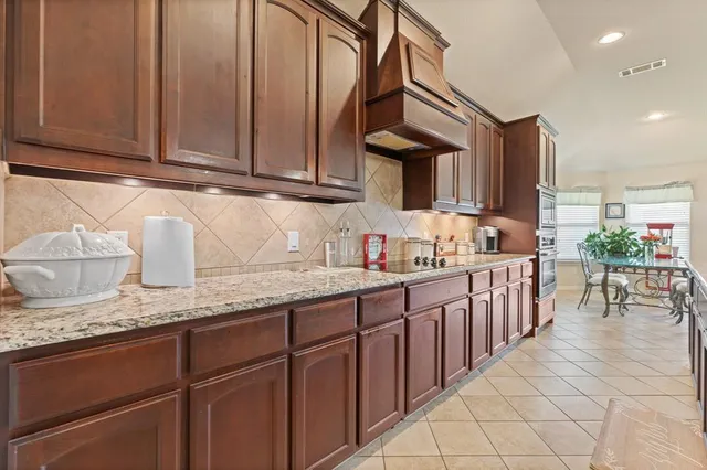 a kitchen with stainless steel appliances granite countertop a stove microwave and cabinets