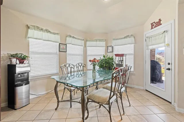 a bedroom with a large bed and a chandelier fan