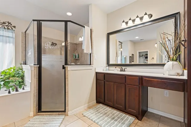 a bathroom with a bathtub sink and mirror