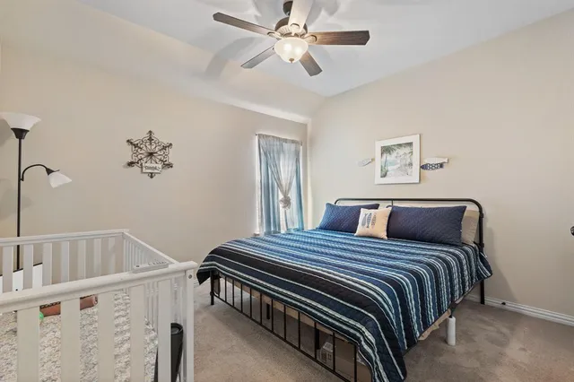 a bed sitting in a bedroom next to a window