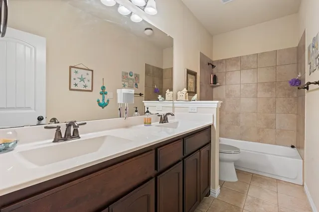 a utility room with cabinets and washer
