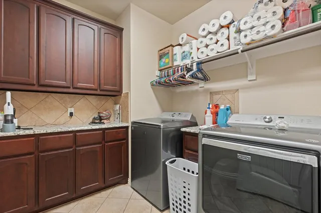 a view of a kitchen with stainless steel appliances wooden floor and a cabinet