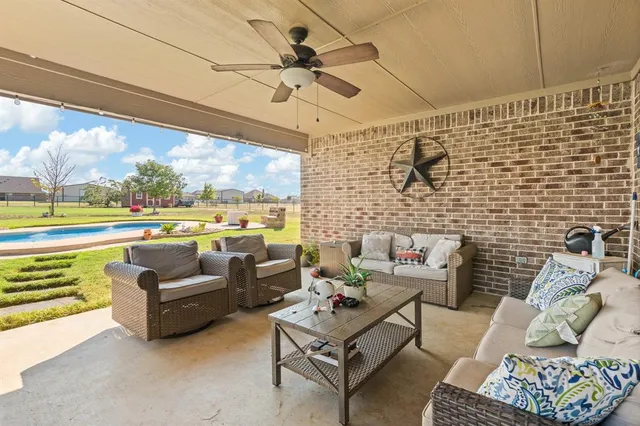 a living room with furniture and floor to ceiling windows