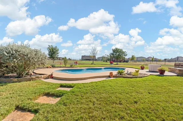 a view of a house with a backyard patio and fire pit