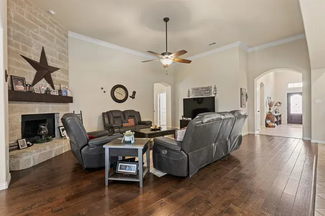a living room with furniture a fireplace and a flat screen tv