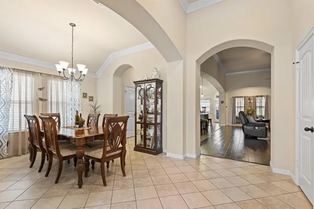 a view of a dining room with furniture and chandelier