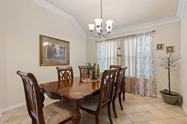 a view of a dining room with furniture and chandelier