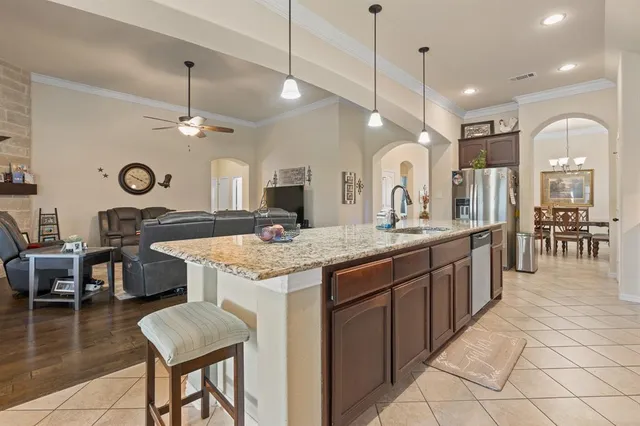 a kitchen with granite countertop a sink and cabinets