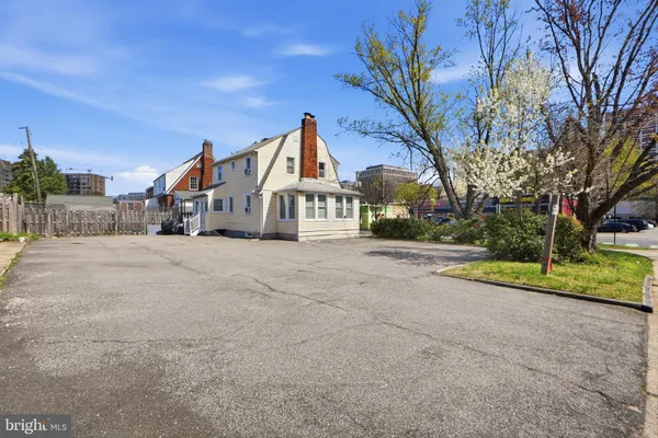 a view of a house with large trees and a big yard