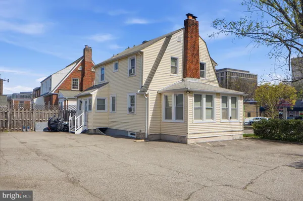 a view of a white house with large windows