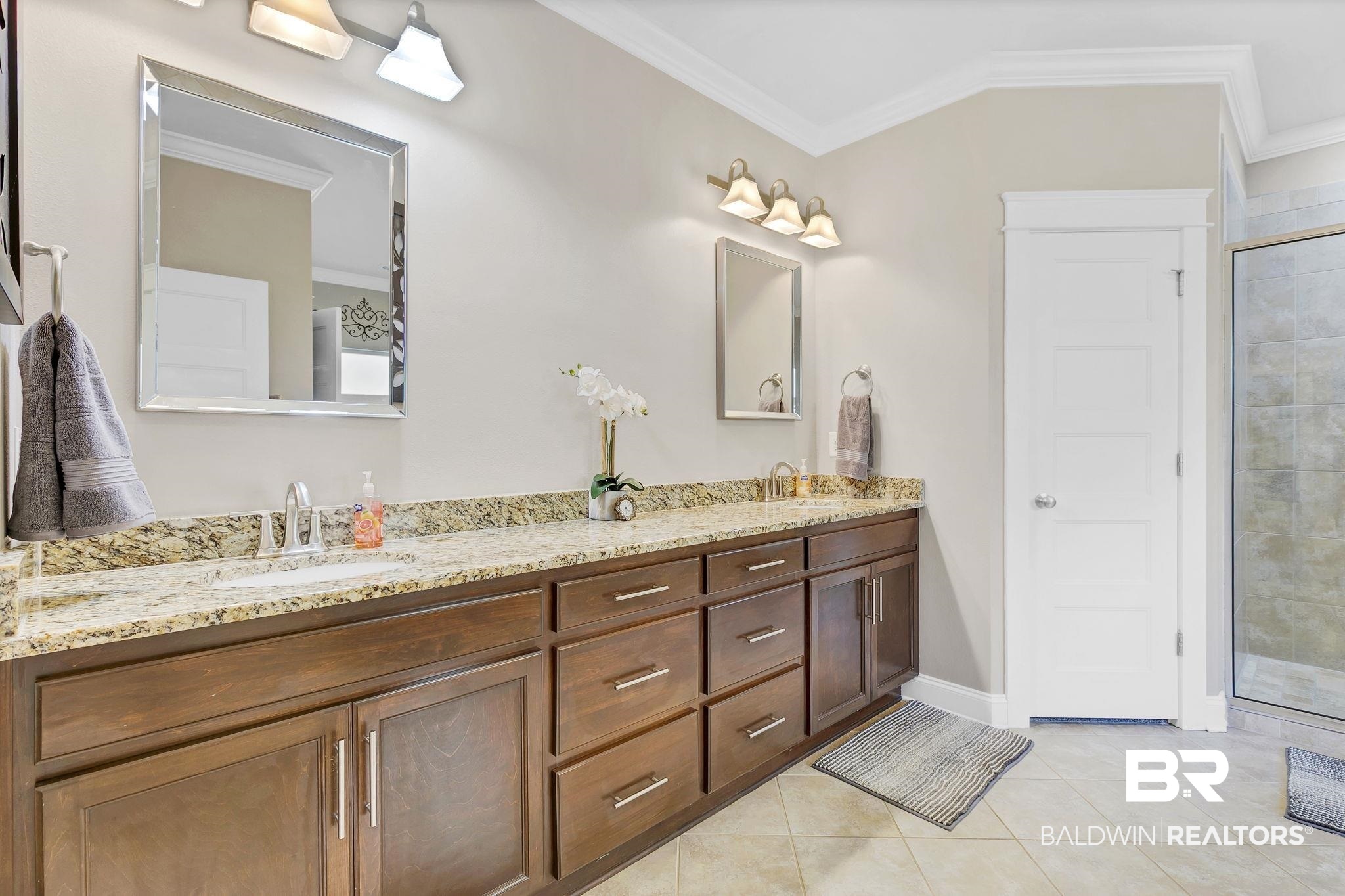 20105 Bunker Loop Fairhope, AL 36532 - Photo 30 of 65 Full bath with a sink, ornamental molding, and tile patterned floors