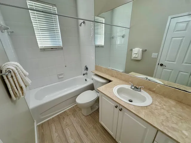 a bathroom with a sink a toilet and a bathtub