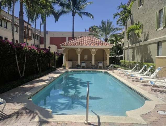 a view of house with swimming pool and yard