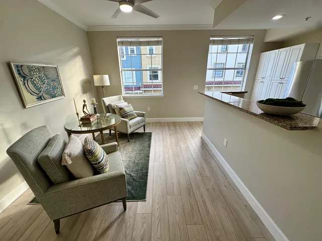 a living room with furniture and wooden floor