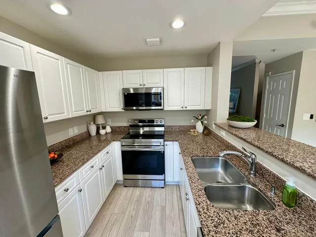 a kitchen with a sink a stove a microwave and refrigerator